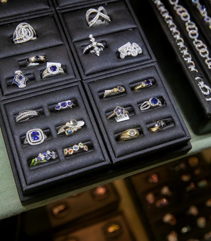 Display trays filled with sapphire and diamond rings in a Palace Jewelers case.