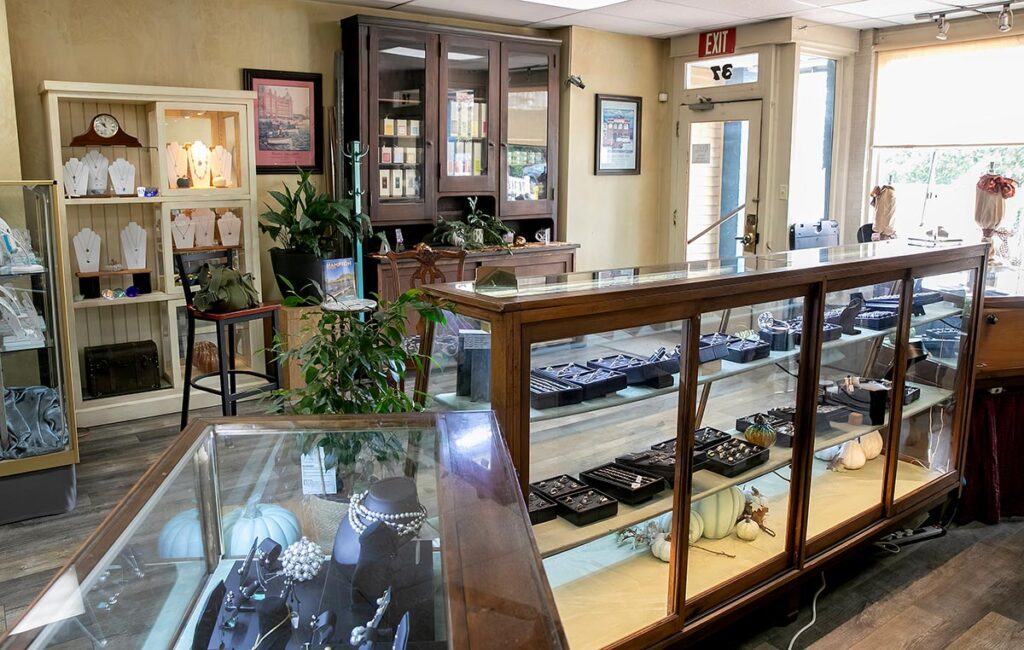 Interior view of Palace Jewelers showing multiple jewelry display cases and shelving.